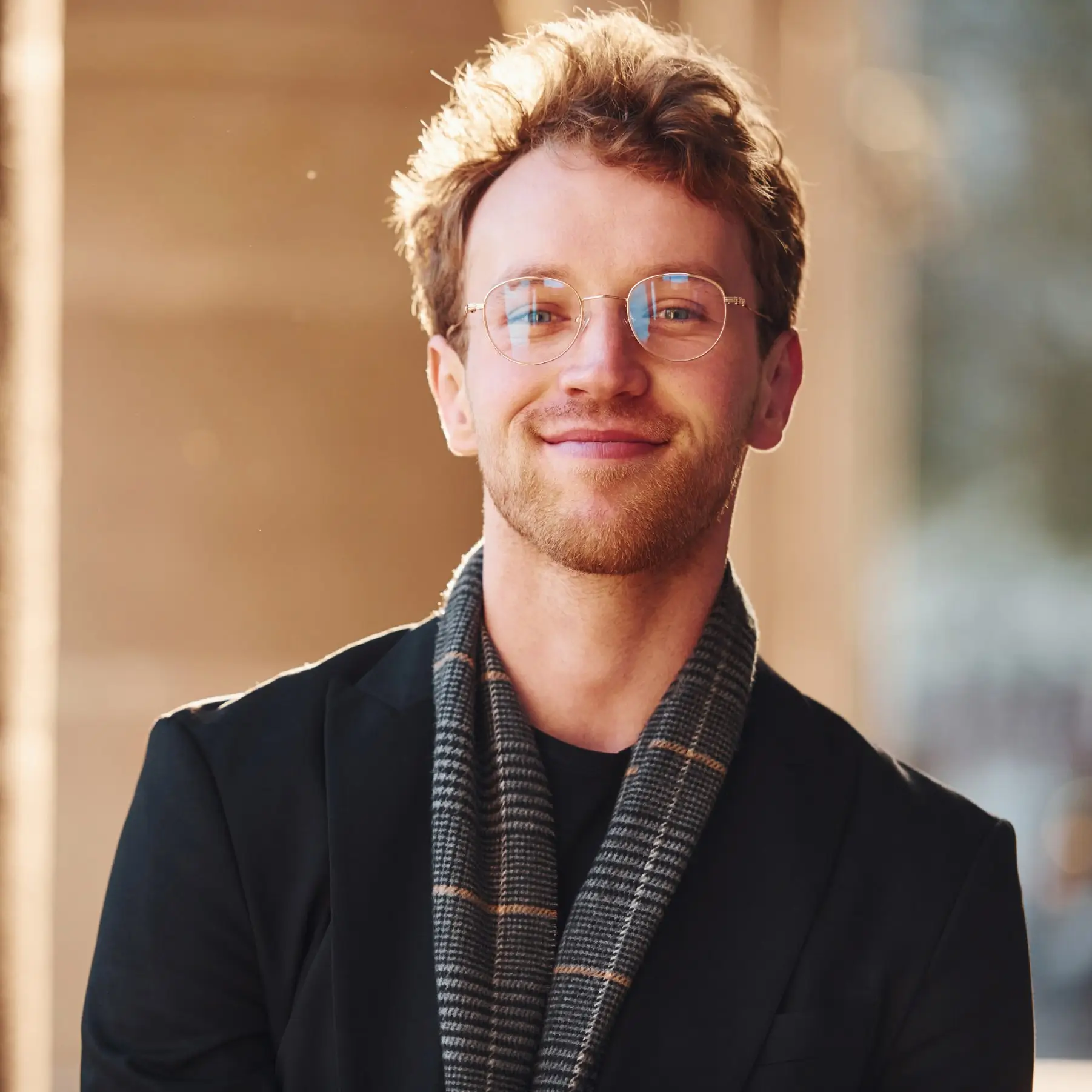 Portrait of Daniel Foster, Dessert Recipe Assistant at GlazeRush, smiling in a warm indoor setting.
