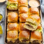 Big Mac-Style Cheeseburger Sliders topped with pickles, lettuce, cheese, and burger sauce
