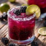 blackberry margarita with fresh berries and lime garnish in a glass
