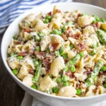 Creamy Summer Pasta Salad with shell pasta, peas, asparagus, and crispy bacon