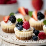 Mini Cheesecakes topped with blueberries, raspberries, blackberries, and strawberries
