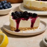 No-Bake Lemon Blueberry Dessert topped with blueberry sauce on a graham cracker crust