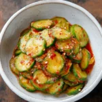 Oi Muchim Korean Cucumber Salad made with sliced cucumbers, sesame seeds, and spicy chili dressing