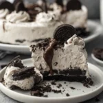 Oreo No-Bake Cheesecake layered in glass cups with creamy filling and cookie crumb crust