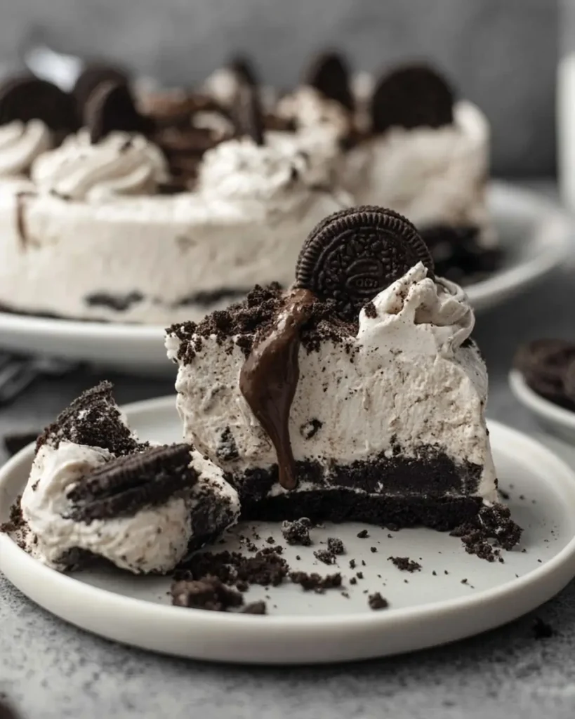 Oreo No-Bake Cheesecake layered in glass cups with creamy filling and cookie crumb crust