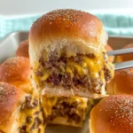 Oven Baked Cheeseburger Sliders filled with melted cheese and seasoned beef on soft buns
