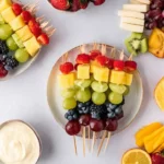 Rainbow-Colored Fruit Kabobs with grapes, pineapple, strawberries, blueberries, and blackberries